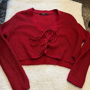 This is a red sweater from Millou. The size is small.
